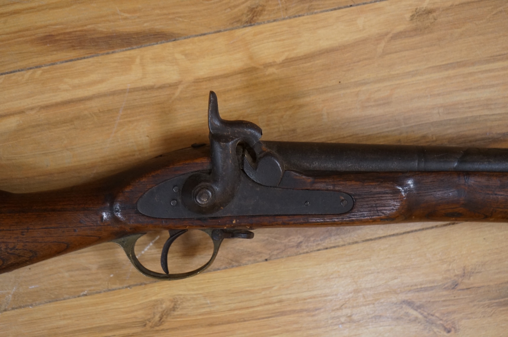 An Indian military style percussion musket, fully stocked, barrel 115cm, with military style brass mounts, iron barrel bands and Enfield style lock, partly 19th century